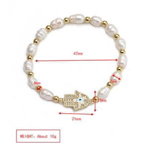 Detailed view of freshwater pearl bracelet with Hamsa hand and blue evil eye charm