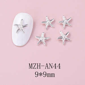 Silver starfish nail charms with pearls, 9x9mm size, shown on a pink textured background