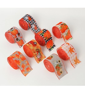 Macro detail of assorted autumn ribbons with pumpkin, maple leaf, and sunflower patterns