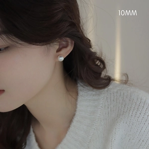 Detailed view of a 10mm white pearl stud earring on model for elegant daily styling