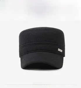 Close-up of black cadet cap featuring wool texture and a metallic Fashion nameplate