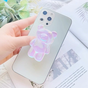 Close-up of a 3D purple gradient bear phone grip stand on a white mobile phone
