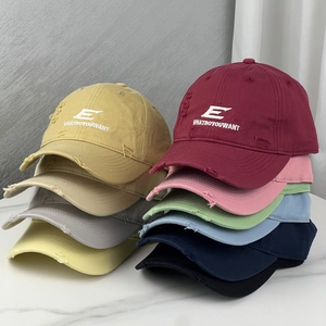 Close-up of distressed cotton baseball caps with vintage embroidery in various colors