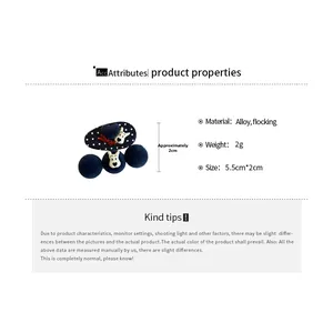 Detail of dark blue flocked hair clip set with puppy motif and polka dot heart design