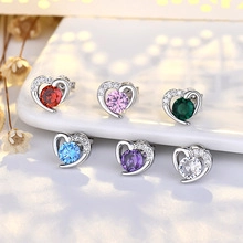 Macro detail of heart-shaped earrings in multiple colors with zircon stones