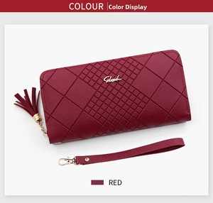Close-up of red quilted leather long wallet featuring tassel zipper and wristlet strap