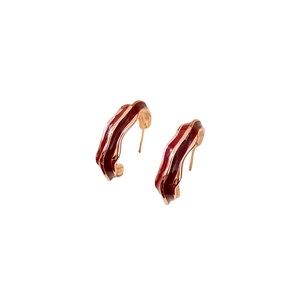 Golden C-shaped wavy earrings with vintage red enamel finish on a clean white background
