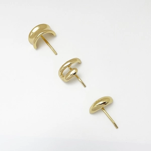 Close-up of minimalist gold alloy hair clips with polished geometric mirror finish surface