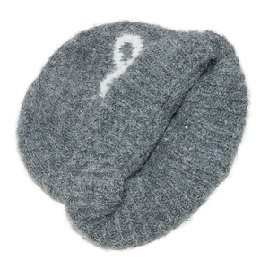 Macro detail of grey knit beanie featuring white woven number 9 pattern and wool texture