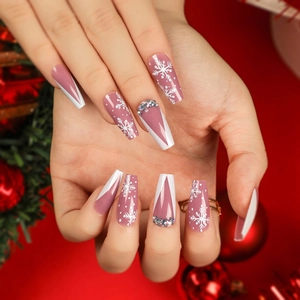 Long coffin Christmas press-on nails with pink ombre, white snowflakes, and small rhinestones