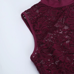 Macro shot of burgundy lace fabric detailing shoulder and cuff craftsmanship on a dress