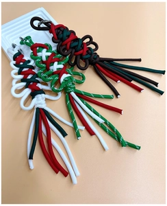 Detailed view of handmade woven paracord keychains in festive Christmas color schemes