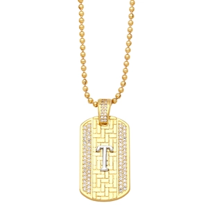 Detail view of golden rectangle pendant with silver letter T and sparkling white zircons