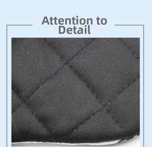 Macro view of black heat-resistant oven mitt with diamond quilted texture and twill fabric