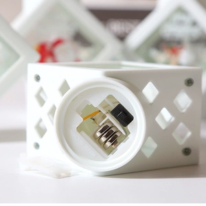 Detail view of the white Christmas lantern base with battery compartment and power switch