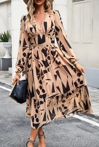 Detail of V-neck printed long sleeve dress featuring beige lace accents and geometric pattern