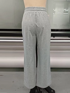 Detail view of the elastic waistband and knit texture on gray wide-leg lounge pants