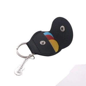 Detail of black leather guitar pick holder keychain with mini guitar charm and colorful picks