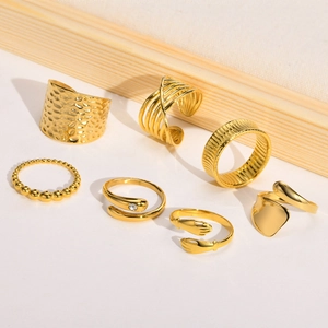 7-piece gold stainless steel ring set featuring zircon accents and textured minimalist designs