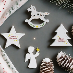 Christmas ornaments set featuring a wooden horse, star, and angel on a dark background