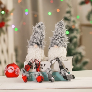 Detail of plush Christmas gnomes with plaid long legs in a warm festive indoor setting