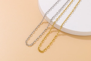 Detail of gold and silver stainless steel cable chains with hammered texture finish