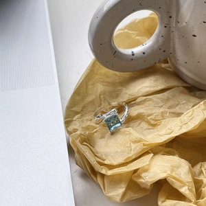 Macro detail of S925 silver ring featuring blue square zircon and hammer texture