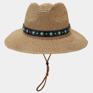 Detail of woven straw hat with turquoise beads, silver studs, and leather band accent