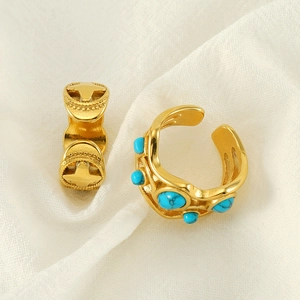 Vintage gold stainless steel rings featuring a cross relief and green malachite inlays