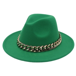 Detailed close-up of emerald green wool fedora hat featuring a chunky gold acrylic chain