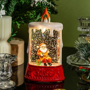 Lighted Christmas candle snow globe with Santa Claus figurine and sparkling glitter