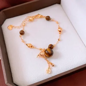 Tiger eye bead bracelet with gold gourd and coin pendants in vintage luxury style