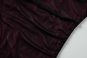 Detail of burgundy ruched mesh fabric with high-quality layered texture and soft sheen