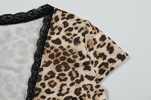 Close-up of V-neckline with black lace trim on a leopard print summer top for women