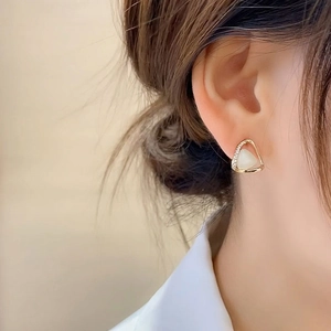 Minimalist triangular cat eye stone earrings with pavé zircons worn on model