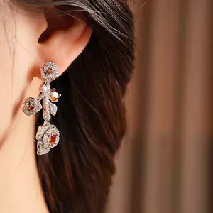 Vintage silver rose drop earrings with amber stones and zircon petals worn by model