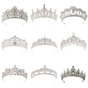 Collection of silver bridal crowns with rhinestones and pearls on a white background