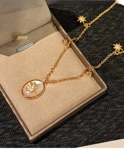 Détail macro du collier en nacre plaqué or 18 carats avec des pendentifs en étoile