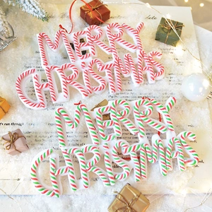 Merry Christmas letter sign ornament with red and green candy cane stripes on snow