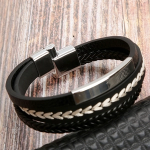 Detail of hand-woven black leather bracelet with silver magnetic stainless steel clasp