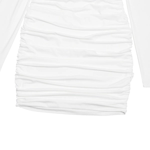 Detail of white draped fabric showing the elegant pleats and soft texture of the dress