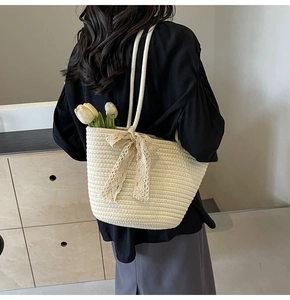 Detail of hand-woven off-white tote bag with lace bow and tulip decoration inside