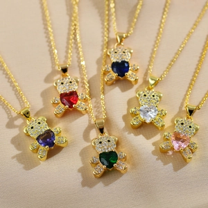 Macro detail of bear necklaces with multi-colored heart-shaped crystals and gold plating