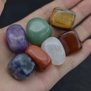 Set of 7 natural raw tumbled healing stones held in hand for yoga and meditation