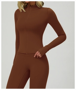 Detail of coffee brown yoga set featuring thumbhole cuffs and a slim fit zip-up jacket