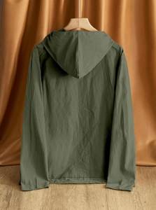 Close-up of military green cotton linen shirt with integrated hood and fabric texture