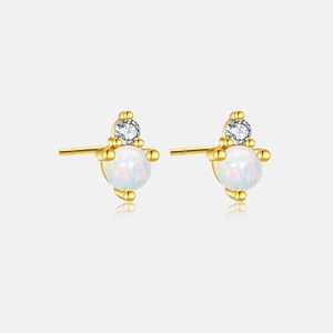 Detailed macro view of S925 silver gold stud earrings with round opal and zircon stones