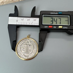Detailed measurement showing the 34.7mm diameter of the religious portrait pendant
