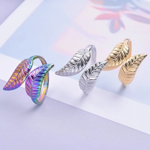 Detail of adjustable double leaf rings in rainbow, silver, and gold steel finishes