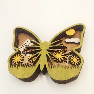Detail of multi-layered wooden butterfly craft showing 3D nature scenery and spring flowers